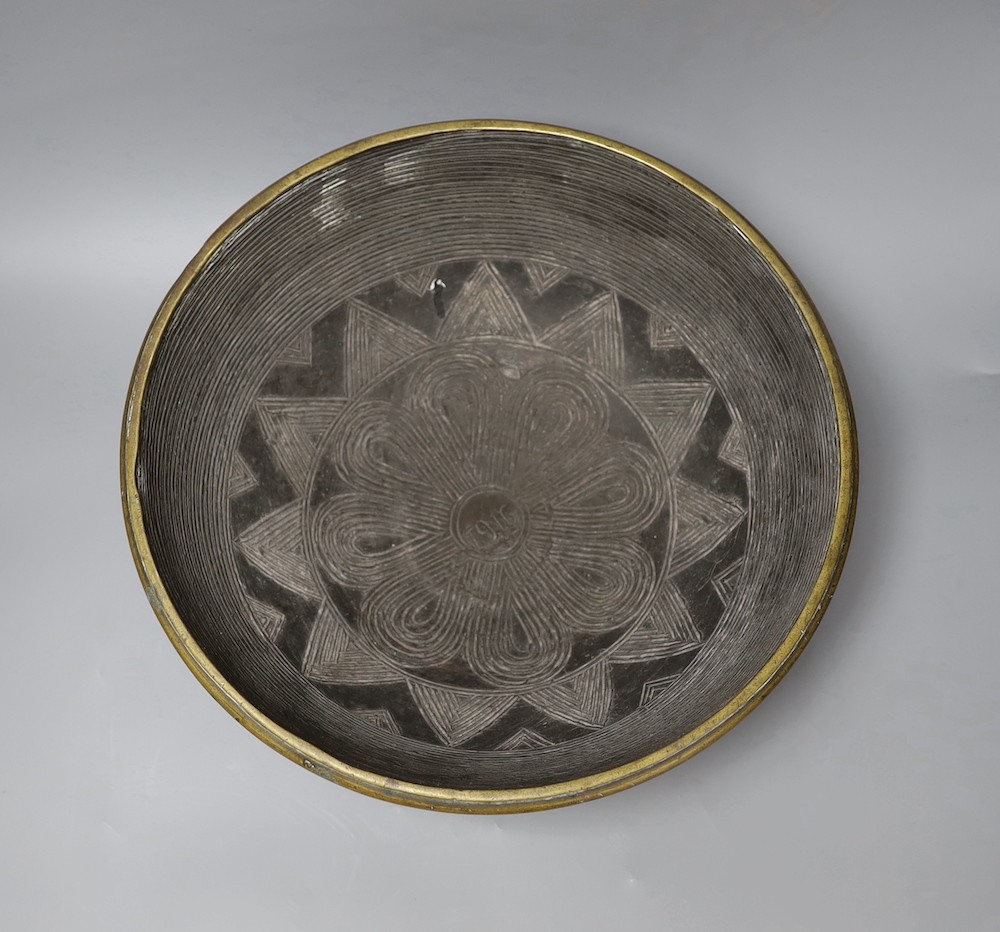 A Himalayan bronze ritual vessel, possibly Tibetan, inscribed 1916 to the interior , 36cms diameter.